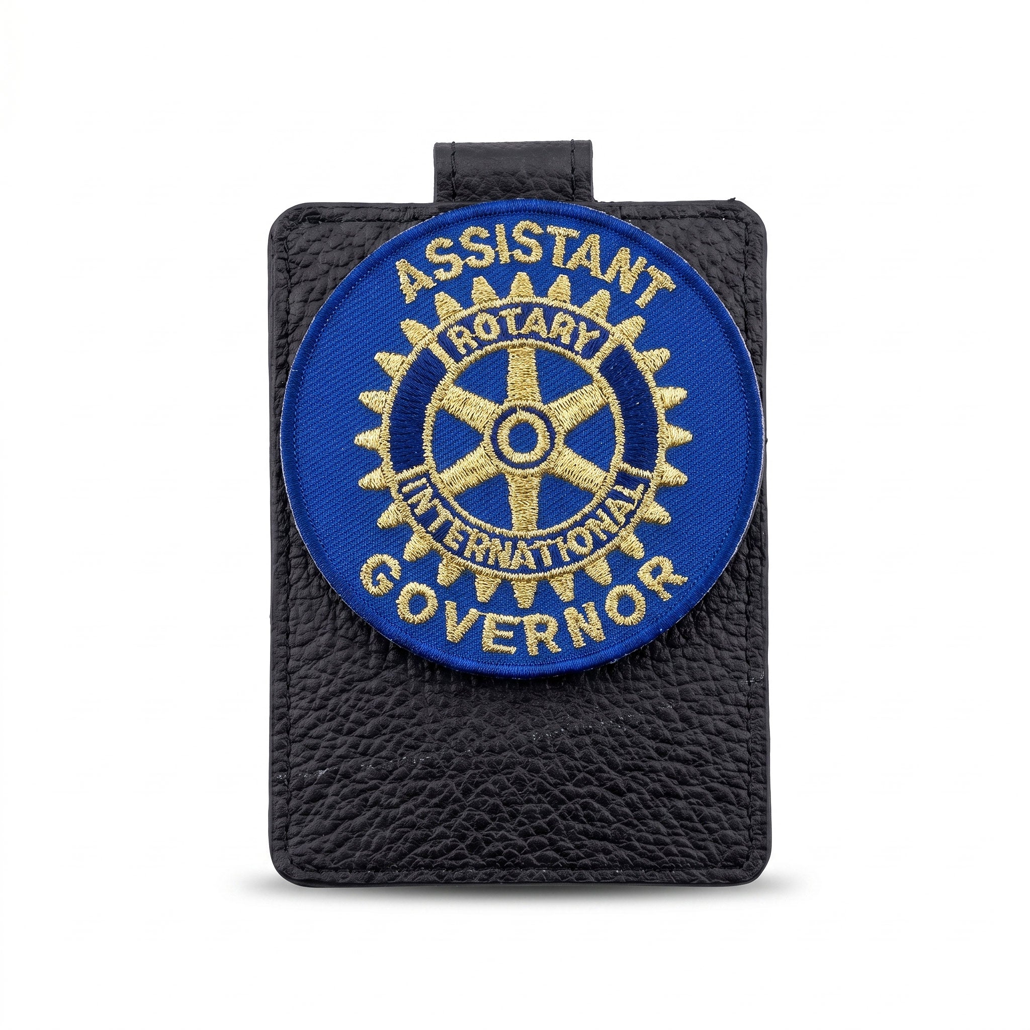 Emblema brodata cu functia de Assistant Governor Rotary International, aplicata pe un suport texturat.